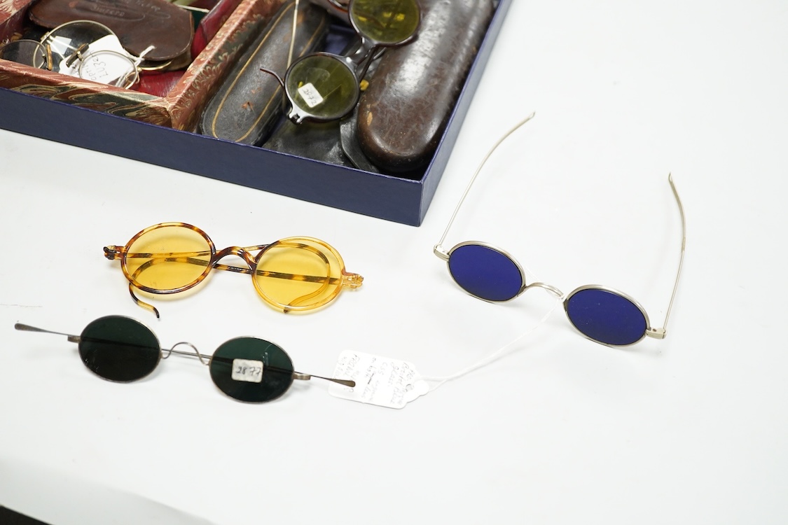 A collection of 18th-20th century steel, nickel, tortoiseshell, brass or faux tortoiseshell spectacles, some cased, five 19th century pince nez, some cased and a quizzing glass etc.